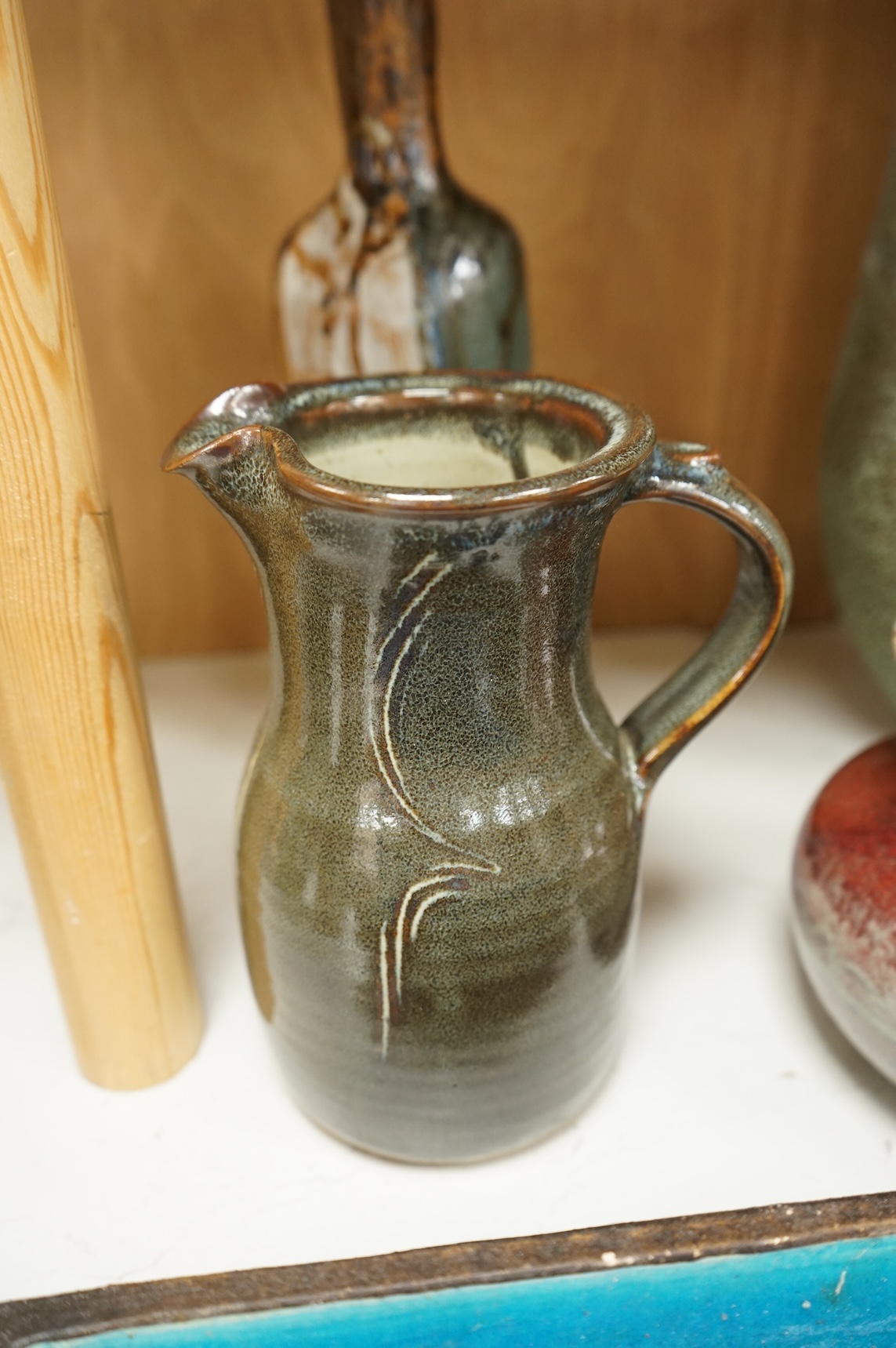 A group of eleven pieces of mixed 1960's-80's pottery to include vases, jugs and two rectangular dishes, largest 34cm high